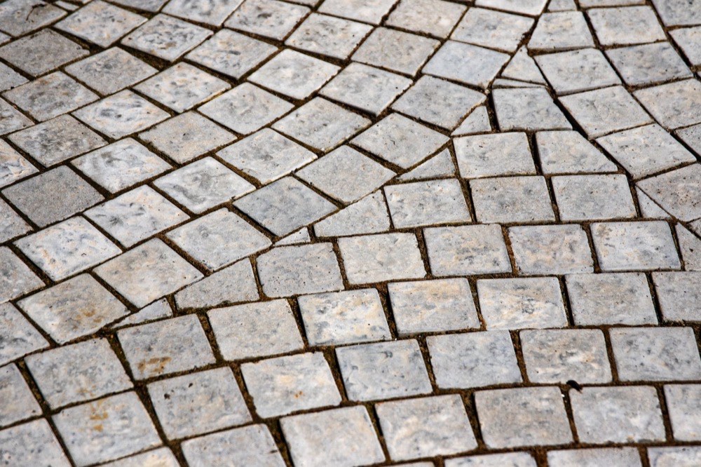 Stone paver setts laid in a fan pattern