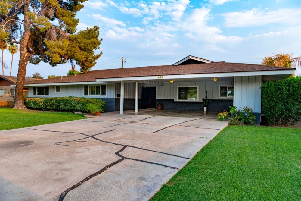 Mid century ranch home with a wide front driveway