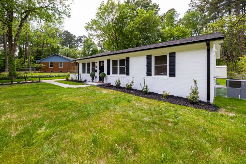 Single story ranch home with front lawn