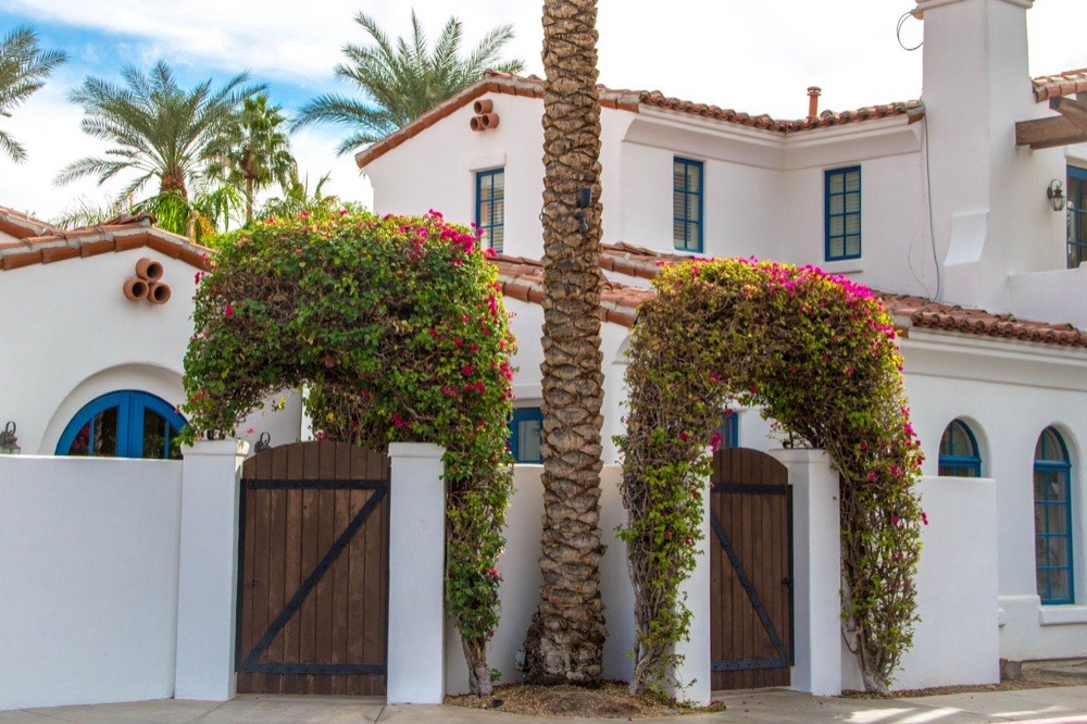 Spanish style villa with courtyard gate and bougainvillea